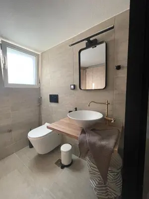 a bathroom with a sink and a toilet and a mirror at PSH -Stylish Quiet Top Floor Apt- Near Acropolis in Athens
