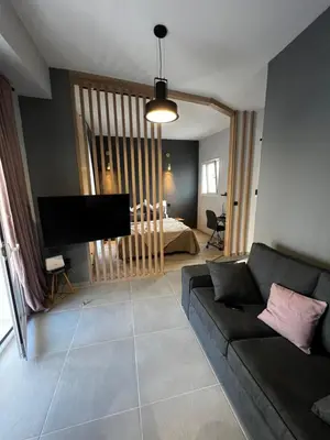 a living room with a couch and a bedroom at PSH -Stylish Quiet Top Floor Apt- Near Acropolis in Athens