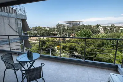 a balcony with a table and chairs and a view at Cozy apartment in Palaio Faliro with a great view (D2) in Athens