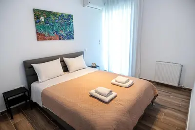 a bedroom with a bed with two towels on it at Cozy apartment in Palaio Faliro with a great view (D2) in Athens