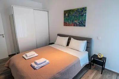 a bedroom with a bed with two towels on it at Cozy apartment in Palaio Faliro with a great view (D2) in Athens