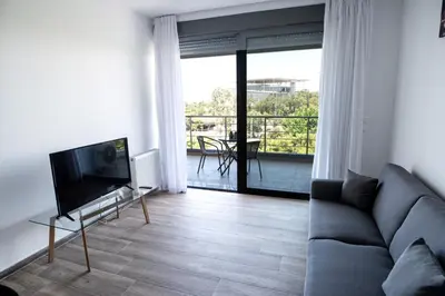 a living room with a couch and a flat screen tv at Cozy apartment in Palaio Faliro with a great view (D2) in Athens