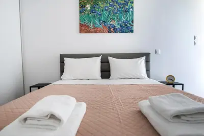 a bedroom with a bed with two towels on it at Cozy apartment in Palaio Faliro with a great view (D2) in Athens