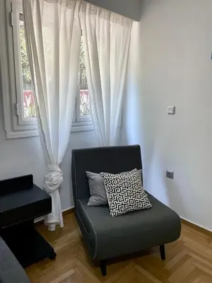 a living room with a couch and a window at Lycabettus Luxury Cave greendom in Athens