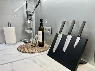 a knife block with a bottle of wine on a counter at Lycabettus Luxury Cave greendom in Athens