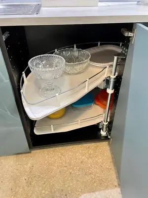 a refrigerator filled with dishes and bowls on a shelf at Lycabettus Luxury Cave greendom in Athens