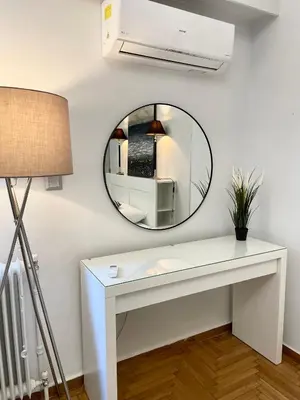 a bathroom with a white vanity and a mirror at Lycabettus Luxury Cave greendom in Athens