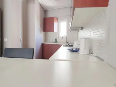 a kitchen with a white counter top in a room at Acropolis Veranda by YHA in Athens