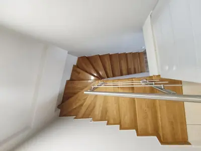a staircase in a room with wood floors and a stair railing at Acropolis Veranda by YHA in Athens
