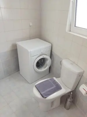 a bathroom with a white toilet and a blue towel at Acropolis Veranda by YHA in Athens