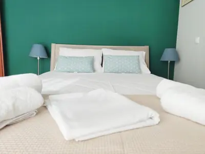 a bedroom with a large bed with white sheets and pillows at Acropolis Veranda by YHA in Athens