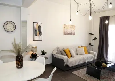 a living room with a couch and a table at Monastiraki Sweet House 2 in Athens