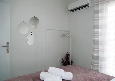 a bedroom with white walls and white towels on a bed at Monastiraki Sweet House 2 in Athens