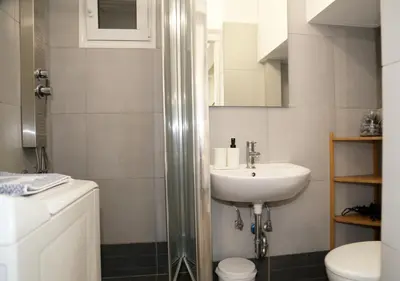 a bathroom with a sink and a toilet and a shower at Monastiraki Sweet House 2 in Athens