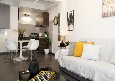 a living room with a couch and a table with chairs at Monastiraki Sweet House 2 in Athens