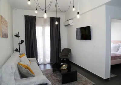a living room with a couch and a bed at Monastiraki Sweet House 2 in Athens