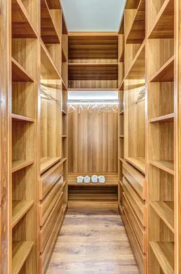 a walk in closet with wooden shelves at EvZin Homes Athens NEa Smyrni in Athens