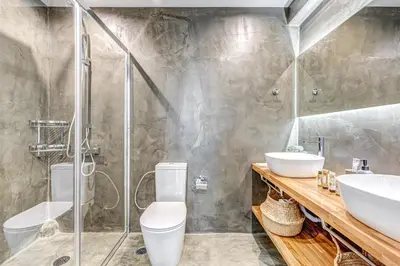 a bathroom with a shower and a toilet and a sink at EvZin Homes Athens NEa Smyrni in Athens