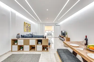 a living room with a couch and a table at EvZin Homes Athens NEa Smyrni in Athens