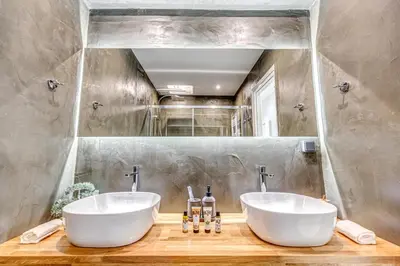 two white sinks in a bathroom with a mirror at EvZin Homes Athens NEa Smyrni in Athens