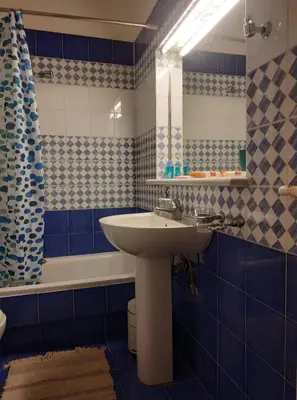 a bathroom with a sink and a mirror and a tub at LG apartment bnb in Athens