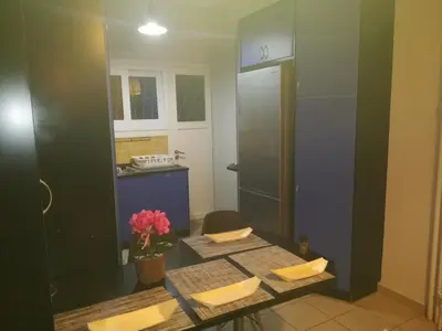 a room with a table and a kitchen with a counter at LG apartment bnb in Athens