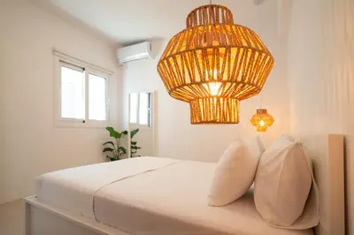 a bedroom with a bed and a chandelier at Private Jacuzzi & Acropolis View - The Suite in Athens