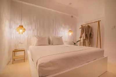 a white bedroom with a bed and two lights at Private Jacuzzi & Acropolis View - The Suite in Athens