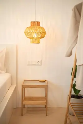 a bedroom with a table and a chandelier at Private Jacuzzi & Acropolis View - The Suite in Athens