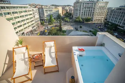 a balcony with a swimming pool and mirrors at Private Jacuzzi & Acropolis View - The Suite in Athens