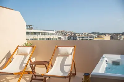 two chairs and a hot tub on a balcony at Private Jacuzzi & Acropolis View - The Suite in Athens