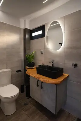 a bathroom with a black sink and a toilet at Private Jacuzzi & Acropolis View - The Urban Loft in Athens