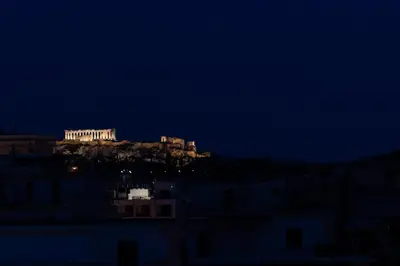 a view of the acropolis at night at Private Jacuzzi & Acropolis View - The Urban Loft in Athens