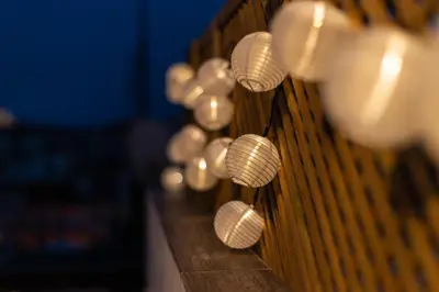 a row of white lights on a wooden bench at Private Jacuzzi & Acropolis View - The Urban Loft in Athens