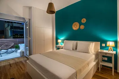 a bedroom with a large bed and a green wall at Private Jacuzzi & Acropolis View - The Athenian Loft in Athens