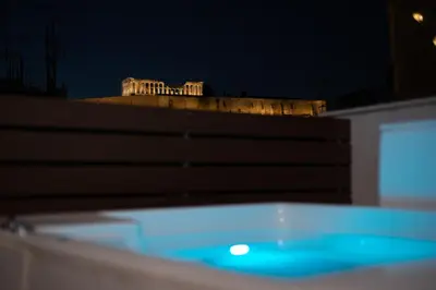a bath tub in front of a building at night at Private Jacuzzi & Acropolis View - The Athenian Loft in Athens
