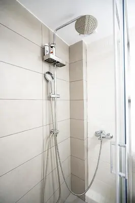 a shower with a shower head in a bathroom at Evaggelismos m station studio for 3 pers by MPS in Athens