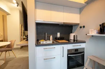 a kitchen with white cabinets and a sink at Evaggelismos m station studio for 3 pers by MPS in Athens