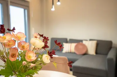 a vase with flowers on a table in a living room at Evaggelismos m station studio for 3 pers by MPS in Athens