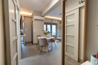a room with a table and chairs and a dining room at Evaggelismos m station studio for 3 pers by MPS in Athens