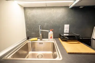 a kitchen with a sink and a toaster oven at Evaggelismos m station studio for 3 pers by MPS in Athens