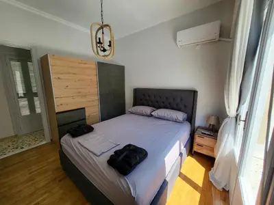 a bedroom with a bed with two bags on it at Maria's Maisonette in Athens