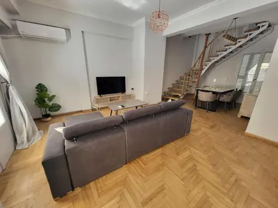 a large living room with a couch and a table at Maria's Maisonette in Athens