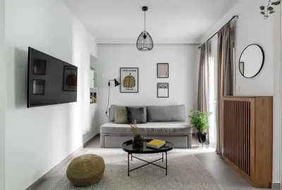 a living room with a couch and a table at Dreamy 1BR Apartment in Kolonaki by UPSTREET in Athens