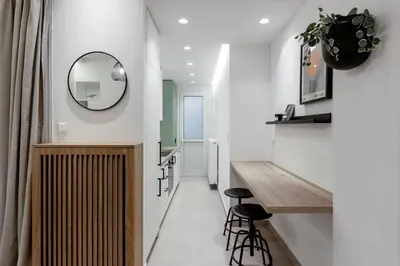 a hallway with a mirror and a vanity and stool at Dreamy 1BR Apartment in Kolonaki by UPSTREET in Athens