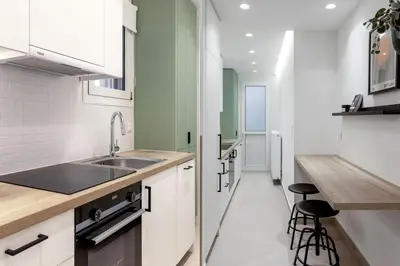a kitchen with white cabinets and a sink and a counter at Dreamy 1BR Apartment in Kolonaki by UPSTREET in Athens