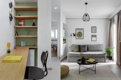 a living room and dining room with a couch and a table at Dreamy 1BR Apartment in Kolonaki by UPSTREET in Athens