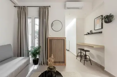 a living room with a couch and a table at Dreamy 1BR Apartment in Kolonaki by UPSTREET in Athens