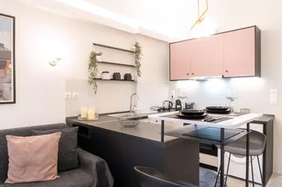 a kitchen with a counter and a chair in a room at Syntagma Sweet House 2 in Athens