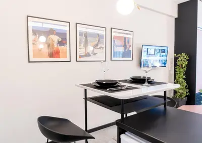 a dining room with a table and a black chair at Syntagma Sweet House 2 in Athens
